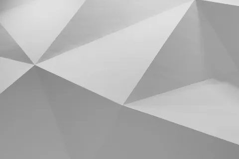 Abstract geometric pattern with white and gray triangular facets creating a 3D effect