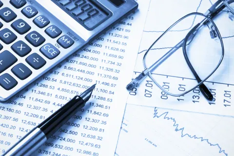 a calculator and glasses on a piece of paper