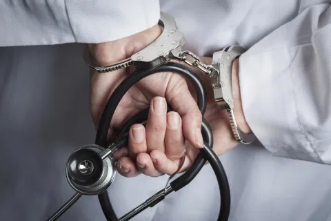 a close-up of a person in handcuffs