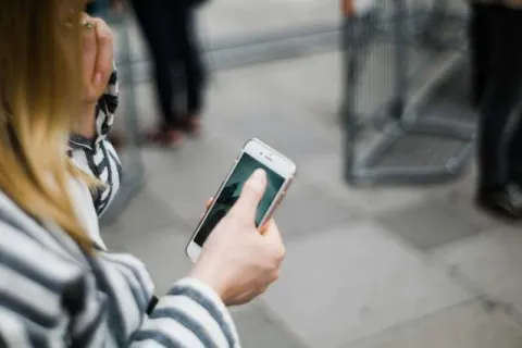 a woman holding a cell phone
