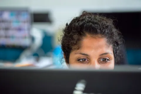 a woman looking at a screen