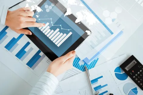a hand pointing at a tablet screen