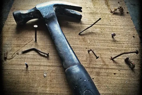 a hammer and nails on a table