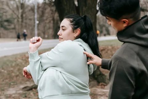 a man helping a woman stretch