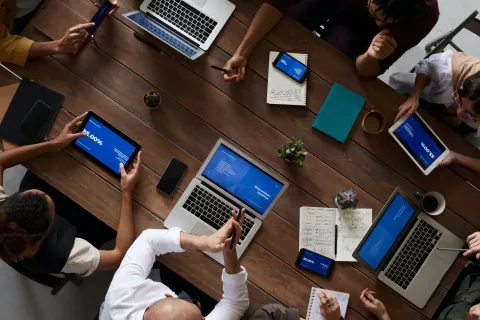 a group of people working on laptops