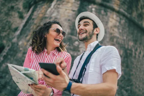 a man and woman looking at a phone