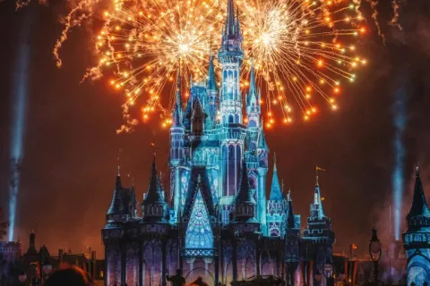 a castle with fireworks in the sky