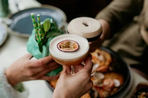 a person holding a cup of food