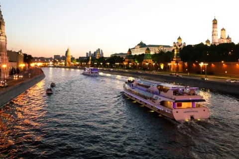a river with boats on it and buildings in the background