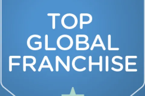 Entrepreneur badge with five blue stars and text announcing top global franchise recognition on blue shield.