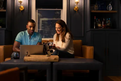 Two franchise owners drinking wine in their living room