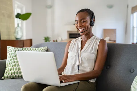 a woman sitting on a couch with a laptop