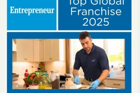 Entrepreneur Top Global Franchise 2025 award banner with man preparing food in kitchen wearing blue gloves.