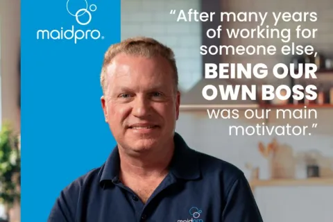 Michael Sharkey, MaidPro owner, smiling wearing MaidPro polo with motivational quote about being own boss.