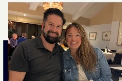 Rick and Jess Hardt smiling at a restaurant table with oysters, representing power couple franchise owners.