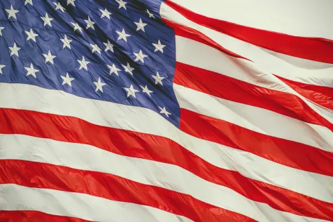 Close-up of the United States flag waving with visible stars and red and white stripes