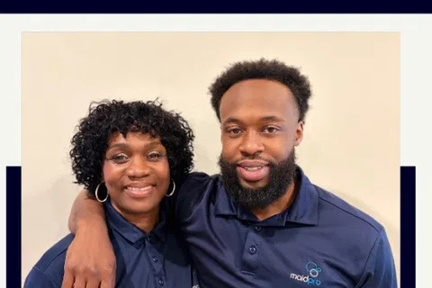 Mother and son franchise owners Linda and Tyrese Watson smiling together in matching Maid Pro uniforms.