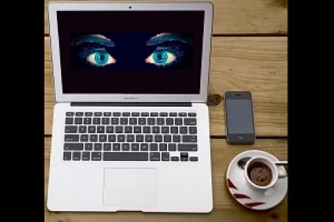 a laptop with a cup of coffee