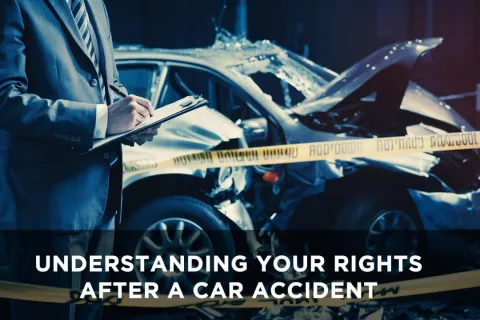 Investigator in suit with clipboard examines damaged car at accident scene behind caution tape.