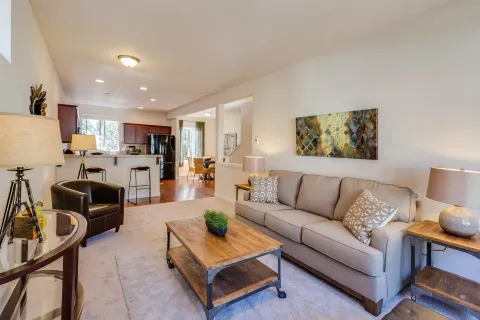 Bright and inviting living room with comfortable sofa, wooden coffee table, and stylish decor.