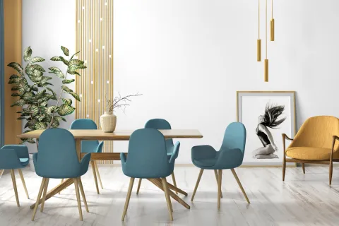 Modern dining room with wooden table, teal chairs, yellow armchair, large plant, and minimalist decor.