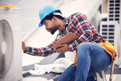 a man in a hard hat working on a machine