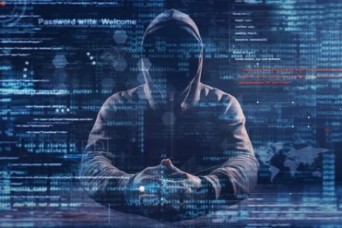 Hacker in dark hoodie surrounded by digital code, cyber security threat concept with data and network graphics.