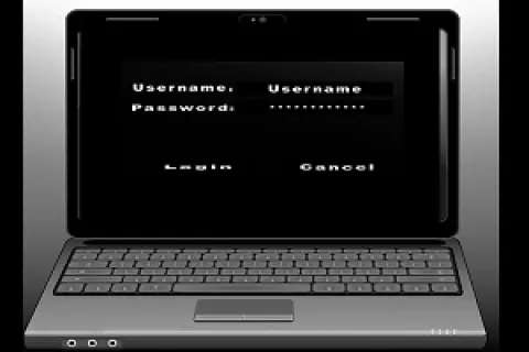 Laptop displaying a login screen with username and password fields and login and cancel buttons.