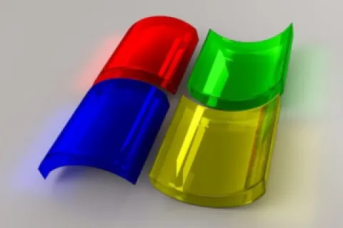 3D translucent red, green, blue, and yellow curved shapes arranged on a gray background.