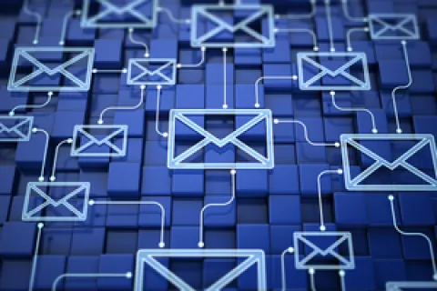 Blue digital envelopes connected by glowing lines over a 3D grid representing email communication network.