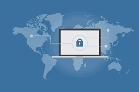 Laptop displaying a lock icon symbolizing global cybersecurity and data protection on a world map background.
