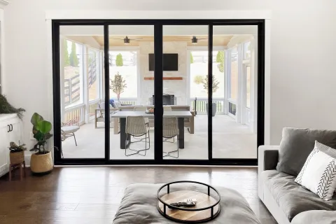 Contemporary living room with large sliding glass doors leading to a spacious outdoor area.