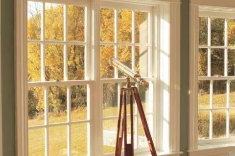a room with windows and a ladder