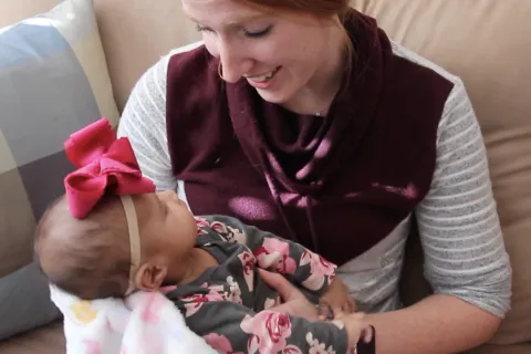 a woman holding a baby