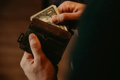 a person holding a wallet