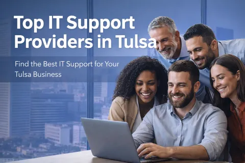 Smiling diverse business team gathered around laptop illustrating top IT support providers in Tulsa for businesses.