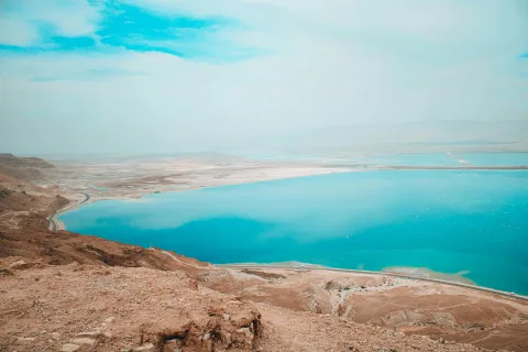 a body of water surrounded by hills
