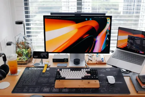 a desk with a laptop and a monitor