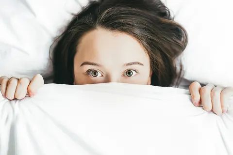 a person lying on a bed