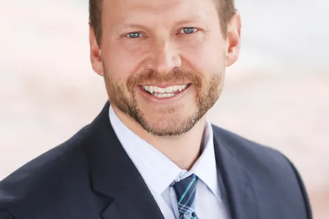 a man in a suit smiling