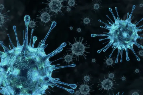 Close-up 3D illustration of blue virus particles with spike proteins floating on a dark background.