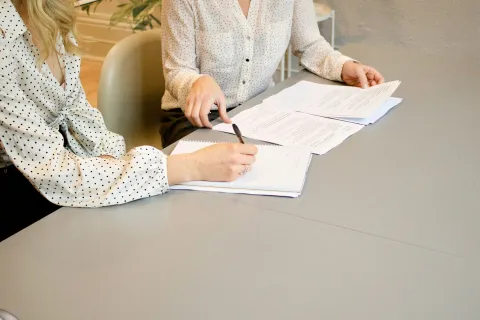 a man and a woman writing on paper
