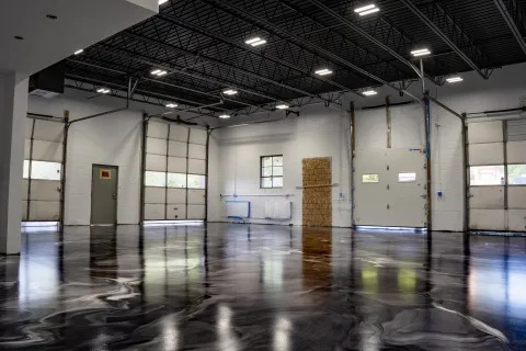 a large empty room with a large glass floor and a large white wall
