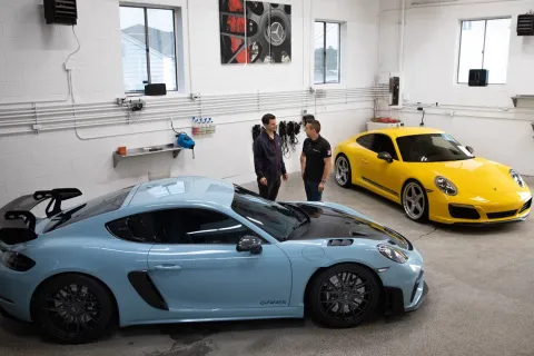 a couple of cars parked in a garage