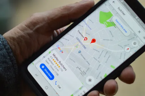 Smartphone showing Google Maps with a pinpoint for Morley Butchers and nearby streets visible.