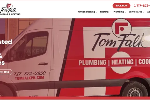 Tom Falk Plumbing & Heating service van featuring company logo and contact information.