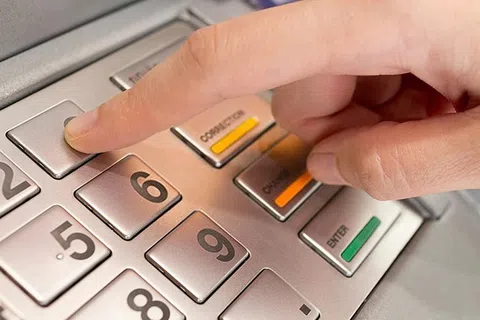 a person's hand on a white keyboard