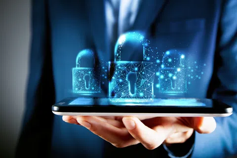 Hand holding a smartphone projecting holographic digital padlocks symbolizing cybersecurity and data protection.