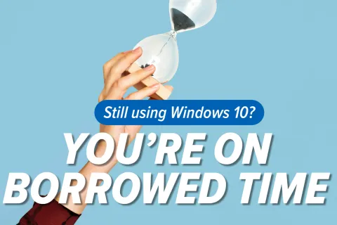 Hand holding hourglass with sand running out and text warning Windows 10 users they're on borrowed time