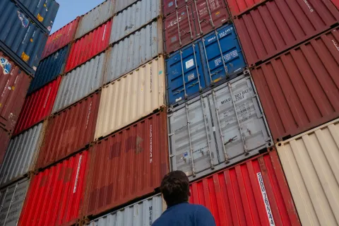 a person standing in front of a red building